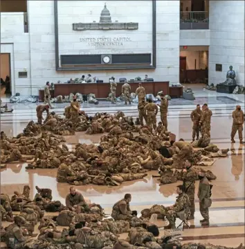  ?? J. Scott Applewhite/Associated Press ?? Hundreds of National Guard troops hold inside the Capitol Visitor's Center on Wednesday to reinforce security at the Capitol in Washington.