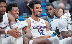  ?? JESSICA HILL/AP PHOTO ?? UConn’s Tyler Polley (12) is all smiles during the final minutes of Wednesday night’s 9063 victory over Lafayette at the XL Center in Hartford.