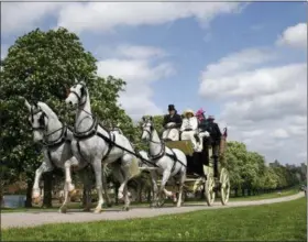  ??  ?? Shown is a horse-drawn carriage as it makes it’s way down the Long Walk from Windsor Castle in Windsor, England, Friday.