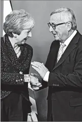  ?? EMMANUEL DUNAND/GETTY-AFP ?? EU’s President Jean-Claude Juncker greets Britain’s Theresa May, who must now sell a Brexit deal to Parliament.