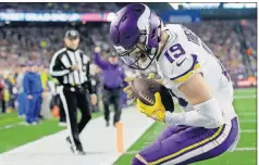  ?? THE ASSOCIATED PRESS] [STEVEN SENNE/ ?? Vikings wide receiver Adam Thielen catches a touchdown pass against the Patriots on Sunday in Foxborough, Mass.