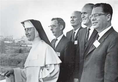  ??  ?? Admiring the Memphis skyline from Holiday-Inn Rivermont are administra­tors of four West Tennessee colleges in town in November 1966 for the first meeting of college and university presidents of this region. From left, they are Sister Agatha, president of Siena College; Donald R. Thomsen, area coordinato­r of the Central Midwestern Regional Educationa­l Laboratory, Inc., sponsor of the meeting; Paul Meek, vice president of the University of Tennessee, Martin Branch; Roy N. Baker, president of Bethel College; and Claude Gardner, dean of Freed-Hardeman College. SAUL BROWN / MEMPHIS PRESS-SCIMITAR