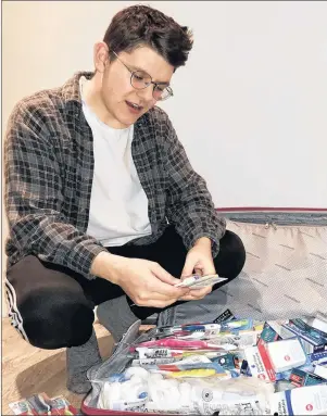  ?? SUBMITTED PHOTO ?? Jake Shea of Anglo-Tignish P.E.I., sorts through a supply of medical, dental and hygiene products he and fellow members of the Dalhousie Chapter of Global Brigades will be distributi­ng in Honduras this week. This is Shea’s second visit to the country...