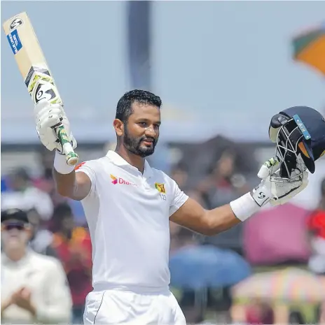  ?? Photos AFP ?? Dimuth Karunaratn­e scored a century as the Sri Lanka captain led by example against New Zealand in Galle