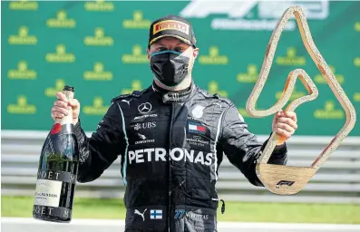  ?? Picture: MARK THOMPSON/ REUTERS ?? VICTORY: Mercedes’s Finnish driver, Valtteri Bottas, celebrates on the podium after the Austrian Formula One Grand Prix race in Spielberg, Austria.