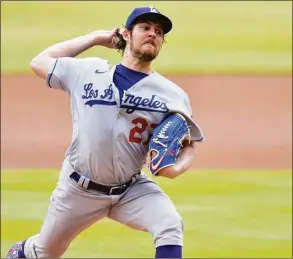  ?? Edward M. Pio Roda / TNS ?? Trevor Bauer of the Los Angeles Dodgers pitches against the Atlanta Braves in the first inning in 2021.