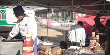  ??  ?? A street vendor prepares a ‘Kota’ sandwich during the Kota Festival on September 8, 2018 at Kliptown in Soweto, South Africa.