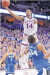  ?? CHARLIE NEIBERGALL/AP ?? Kansas’ Malik Newman (14) is fouled on his way to the basket by Duke’s Wendell Carter Jr. (34) during overtime.