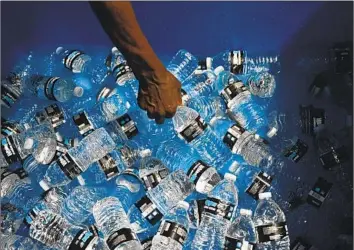  ?? Patrick T. Fallon AFP/Getty Images ?? SCIENTISTS at Columbia University examined water samples from three popular brands (they won’t say which ones) and found hundreds of thousands of bits of plastic per liter. Ninety percent were nanoplasti­cs.