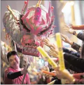  ?? PICTURE: EPA ?? GOOD FORTUNE: Revellers reach out to touch the head of a paper dragon during a dance at the Internatio­nal Chinese New Year night parade held in Hong Kong.
