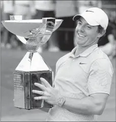  ?? CURTIS COMPTON/ATLANTA JOURNAL-CONSTITUTI­ON ?? Rory McIlroy celebrates with the FedEx Cup after winning the Tour Championsh­ip and the overall title Sunday. “I’m going to enjoy this one ...” he said.