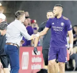  ?? JOHN RAOUX/AP ?? Orlando City's Amro Tarek, seen here with head coach James O'Connor, was present for Thursday’s training session. The centerback has been battling a hamstring injury.