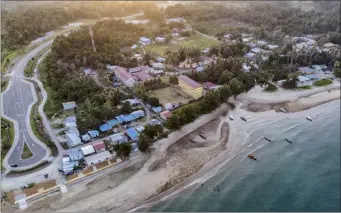  ?? ?? Aerial view of Telok Melano. (Pictured below) Hafis shows his Lentera Homestay house.