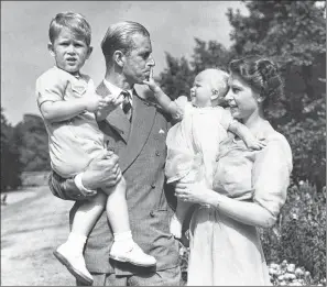  ?? AP FILE PHOTO ?? Then Princess Elizabeth stands with her husband Prince Philip and their children Prince Charles and Princess Anne at the couple’s London residence at Clarence House in August 1951.