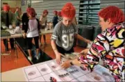  ?? BOB RAINES — DIGITAL FIRST MEDIA ?? Student Sydney Peoples and parent Lisa Hoffman lay out meal pouches on a grid assuring a proper meal count for each box packed during a Rise Against Hunger meal packing event at Pennridge North Middle School.