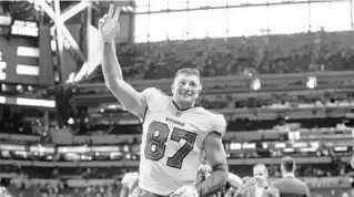  ?? JEFF LEWIS/AP ?? Buccaneers tight end Rob Gronkowski walks off the field after Sunday’s 38-31 win over the Colts in Indianapol­is. Gronkowski had seven receptions for 123 yards in the victory.