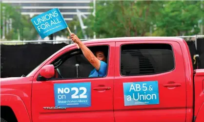  ?? Photograph: Frederic J Brown/AFP/Getty Images ?? ‘With Propositio­n 22’s passage, the tech underclass will remain overworked and underpaid, unable to access unemployme­nt insurance, paid family leave or healthcare during a pandemic.’