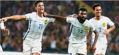  ??  ?? We’re ahead: Malaysia’s N. Thanabalan (centre) celebratin­g after scoring with a header in the semi-final against Indonesia at the Shah Alam Stadium last night. Malaysia won 1- 0.