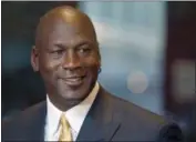  ?? CHARLES REX ARBOGAST — THE ASSOCIATED PRESS FILE ?? In this file photo, former NBA star and current owner of the Charlotte Hornets, Michael Jordan, smiles at reporters in Chicago. Jordan announced Monday he’s giving $1 million to the Institute for Community-Police Relations and $1 million to the NAACP...