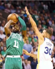  ??  ?? Kyrie Irving ( left) of the Boston Celtics goes for a shot in their NBA game against Golden State Warriors at TD Garden in Boston, Massachuse­tts on Thursday. The Celtics won 92- 88.