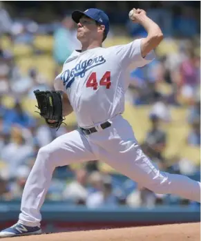  ?? (Photo by Mark J. Terrill, AP) ?? Los Angeles Dodgers starting pitcher Rich Hill throws to the plate during the first inning of Saturday’s game.