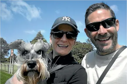  ??  ?? Rio, the schnauzer, with his companion humans Lillian Richmond and Michael Terry. Richmond and Terry own the Animal Outfitters online store.