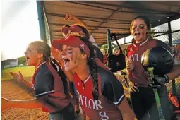  ?? STAFF PHOTO BY DOUG STRICKLAND ?? Baylor players cheer in the dugout after scoring a run during their second win Friday night against rival GPS. The Bruisers beat Baylor 7-1 on Thursday.