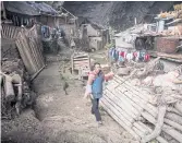  ??  ?? QUIET LIFE: A woman walks through Zhongdong. Most villagers are from the Miao minority.