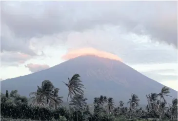  ?? AP ?? Mt Agung volcano is seen at sunrise in Karangasem, Bali yesterday. Dire warnings of an impending eruption have caused tens of thousands to flee the resort island.