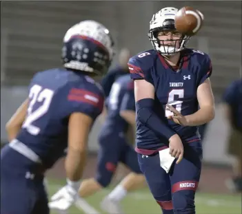  ?? Dan Watson/The Signal ?? Trinity quarterbac­k Rick Roberts (6) passes the ball to Edgar Romero (32) in the first quarter against South Torrance at Canyon High School on Nov. 8. Roberts recently committed to California Lutheran.