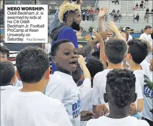  ?? Paul Schwartz ?? HERO WORSHIP: Odell Beckham Jr. is swarmed by kids at his Citi Odell Beckham Jr. Football ProCamp at Kean University on Saturday.