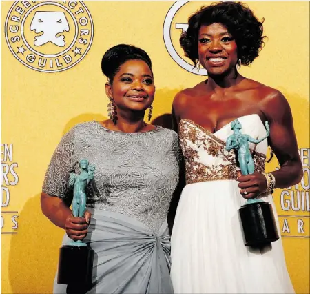  ?? FREDERIC J. BROWN, Afp/getty Images ?? Viola Davis, right, seen with Octavia Spencer, opted for a flowing white Marchesa gown with a gold embroidere­d bustier.