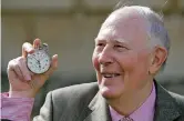  ??  ?? Sir Roger Bannister, who ran the first sub-4-minute mile in 1954, holds the stop watch used by Harold Abrahams to time the race during 50th anniversar­y celebratio­ns at Pembroke College, Oxford, on May 6, 2004. — Reuters