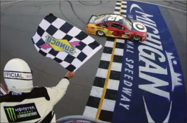  ?? CHRIS TROTMAN — NASCAR VIA AP ?? Kyle Larson takes the checkered flag to win the FireKeeper­s Casino 400 on June 18 at Michigan Internatio­nal Speedway.