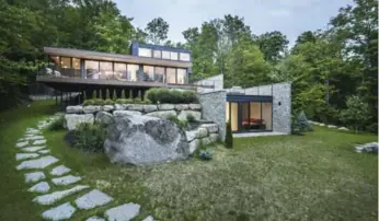  ?? ULYSSE LEMERISE BOUCHARD PHOTOS ?? The design concept has the house emerging from the rocky topography and blending with nature.