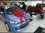  ?? CARLOS OSORIO — THE ASSOCIATED
PRESS ?? In a photo from Thursday people walk through the Taylor Chevrolet showroom in Taylor, Mich. At car dealership­s, they call it the payment walk, when someone with a low credit score wants to buy a new car but gets walked to the used lot because they...