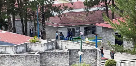  ??  ?? House of pain: Workers cleaning blankets at the Virgen de la Asuncion Safe Home in San Jose Pinula, Guatemala, after the March 8 fire that killed 40 girls and injured many others. — AP