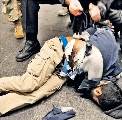  ??  ?? The bomber lies seriously injured on the floor of the New York underpass after detonating a homemade pipe bomb strapped to his body