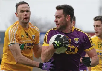  ??  ?? Goalscorer Daithí Waters considers his options as Ricky Johnston (Antrim) applies pressure.