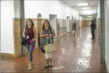  ?? Pittsburgh Post-Gazette ?? Teachers and support staff walk the newly painted hallways inside the Clairton City School District Education Center on Wednesday.