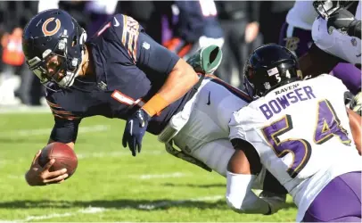  ?? GETTY IMAGES ?? Bears rookie quarterbac­k Justin Fields left the game Sunday against the Ravens with an injury to his ribs.
