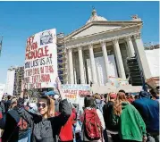  ??  ?? Carl Albert High School student Andie McDermott holds a sign referencin­g comments by Rep. Kevin McDugle, R-Broken Arrow, during the third day of a walkout by Oklahoma teachers at the Capitol in Oklahoma City.