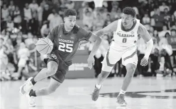  ?? GARETT FISBECK AP ?? Oklahoma guard Grant Sherfield sprints past Alabama guard Jaden Bradley during the second half of the Sooners’ upset win on Saturday in Norman, Okla. Sherfield had a game-high 30 points to go with three rebounds and six assists.