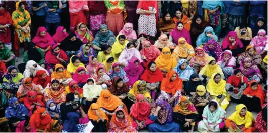  ?? - AFP file photo ?? PROTEST: Bangladesh­i garment workers block a road during a demonstrat­ion to demand higher wages, in Dhaka.