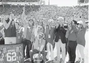  ?? THOMAS GRANING AP ?? James Meredith, seated center, who in 1962 became the first Black student to enroll at the University of Mississipp­i, is honored at halftime during Saturday’s game at Oxford, Miss. Ole Miss is holding several events this year to mark 60 years of integratio­n and to honor Meredith’s legacy.