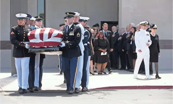  ?? DAVID WALLACE/USA TODAY NETWORK ?? Members of the U.S. military carry the flag-draped casket of Sen. John McCain as Jack McCain, right, escorts his mother, Cindy.