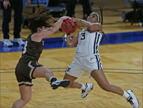  ?? Associated Press ?? West Virginia guard Kirsten Deans, right, is fouled by Lehigh guard Clair Steele, left, during a first-round game in the women’s NCAA tournament Sunday at the Greehey Arena in San Antonio, Texas.