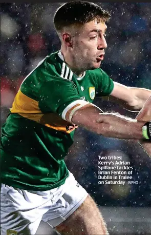  ?? INPHO ?? Two tribes: Kerry’s Adrian Spillane tackles Brian Fenton of Dublin in Tralee on Saturday