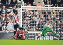  ?? Picture: Getty. ?? Joselu shoots past Simon Mignolet to level for Newcastle against Liverpool.