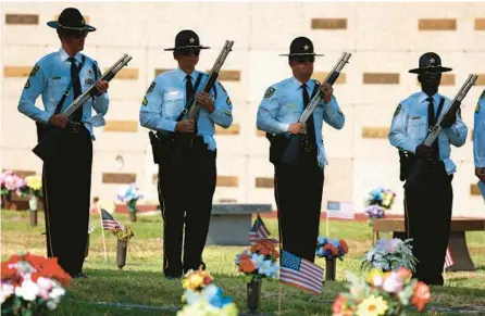  ?? JOE BURBANK/ORLANDO SENTINEL FILE ?? Members of the Orange County Sheriff’s Office Honor Guard prepare for a rifle volley during the 71st Annual Woodlawn Memorial Day Service at the cemetery in Gotha in 2021.